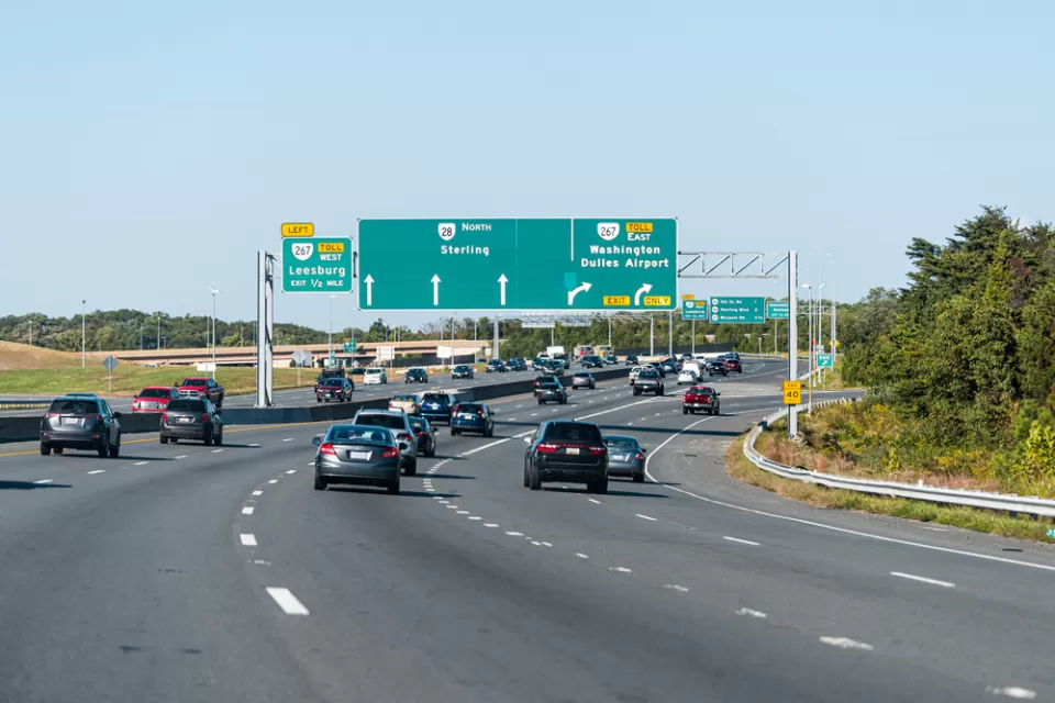 Herndon, USA - October 7, 2020: Sully road 28 multiple lane highway in Northern Virginia with traffic cars and exit sign for Washington Dulles airport, Sterling and Leesburg